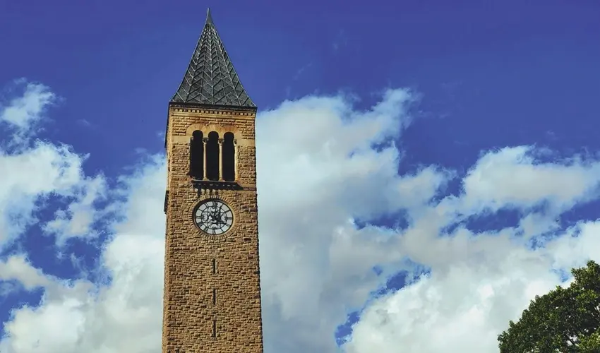 Cornell Clock tower with a cloudy blue sky