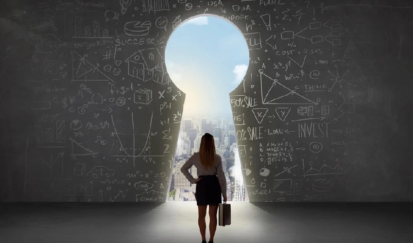 Business woman looking at keyhole with bright cityscape