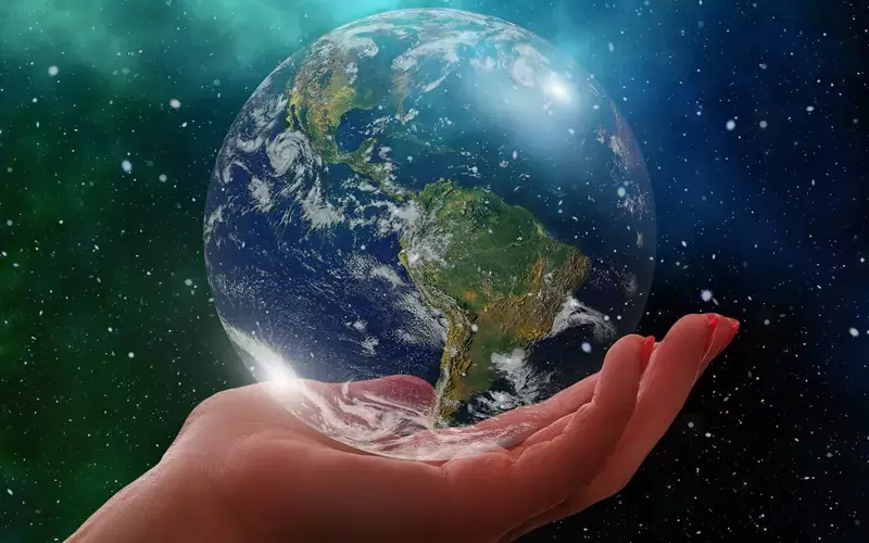 Earth in space being held in hand