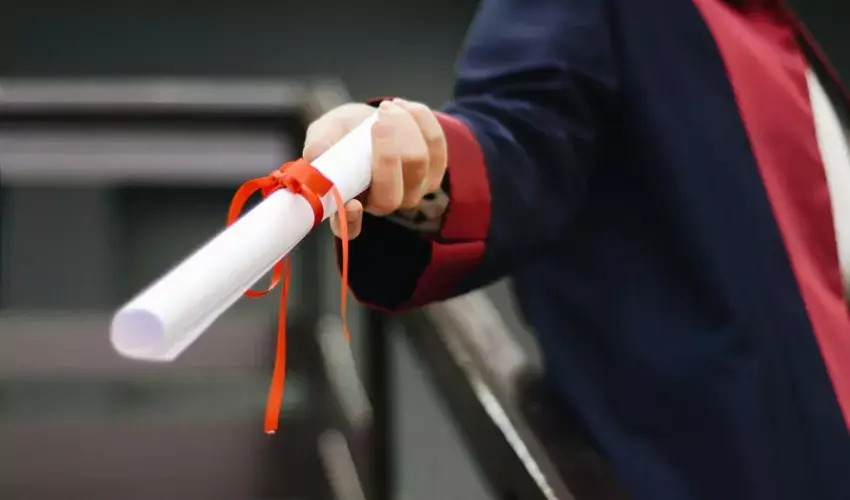 Graduate holding a diploma