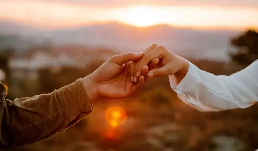 Holding hands at sunset